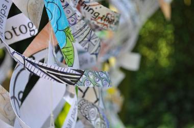 Hanging ribbons with words and colourful patterns on.